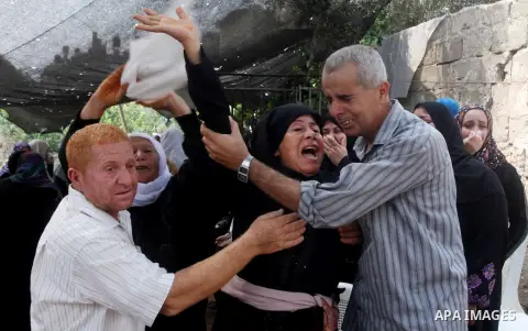 Relatives of Palestinian fisherman Fahmi Abu Rayash mourn over his body during his funeral in Beit Lahia in the northern Gaza Strip on September 29, 2012. Abu Rayash died of his wounds after the Israeli navy opened fire...
