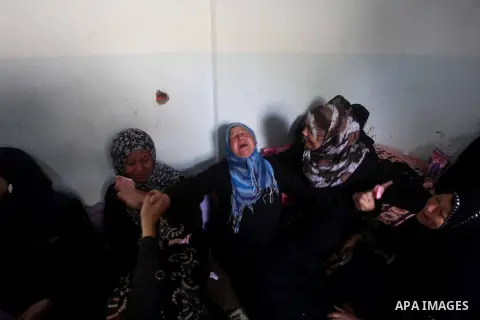 Relatives of Palestinian fisherman Fahmi Abu Rayash mourn over his body during his funeral in Beit Lahia in the northern Gaza Strip on September 29, 2012. Abu Rayash died of his wounds after the Israeli navy opened fire...