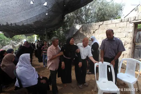 Relatives of Palestinian fisherman Fahmi Abu Rayash mourn over his body during his funeral in Beit Lahia in the northern Gaza Strip on September 29, 2012. Abu Rayash died of his wounds after the Israeli navy opened fire...