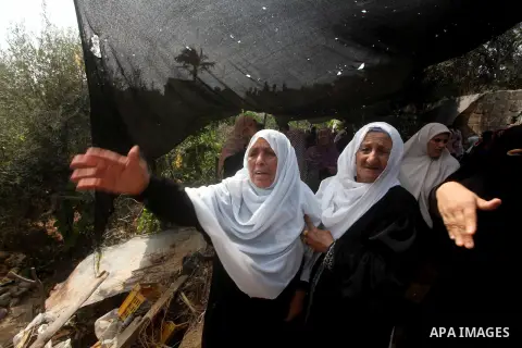 Relatives of Palestinian fisherman Fahmi Abu Rayash mourn over his body during his funeral in Beit Lahia in the northern Gaza Strip on September 29, 2012. Abu Rayash died of his wounds after the Israeli navy opened fire...