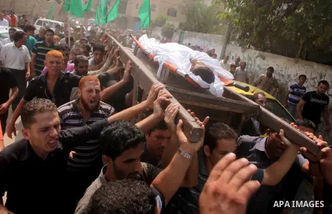 Palestinian mourners carry the body of fisherman Fahmi Abu Rayash during his funeral in Beit Lahia in the northern Gaza Strip on September 29, 2012. Abu Rayash died of his wounds after the Israeli navy opened fire on his...