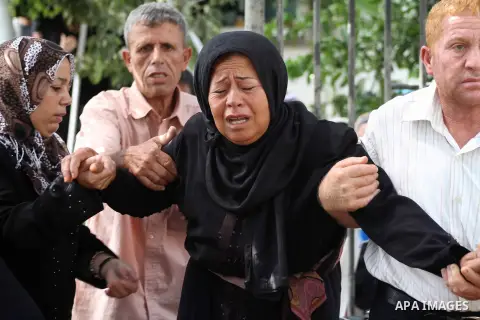 Relatives of Palestinian fisherman Fahmi Abu Rayash mourn over his body during his funeral in Beit Lahia in the northern Gaza Strip on September 29, 2012. Abu Rayash died of his wounds after the Israeli navy opened fire...