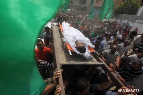 Palestinian mourners carry the body of fisherman Fahmi Abu Rayash during his funeral in Beit Lahia in the northern Gaza Strip on September 29, 2012. Abu Rayash died of his wounds after the Israeli navy opened fire on his...