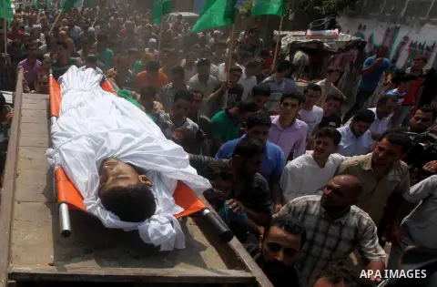 Palestinian mourners carry the body of fisherman Fahmi Abu Rayash during his funeral in Beit Lahia in the northern Gaza Strip on September 29, 2012. Abu Rayash died of his wounds after the Israeli navy opened fire on his...