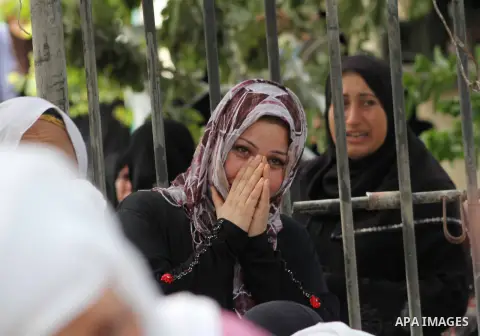 Relatives of Palestinian fisherman Fahmi Abu Rayash mourn over his body during his funeral in Beit Lahia in the northern Gaza Strip on September 29, 2012. Abu Rayash died of his wounds after the Israeli navy opened fire...