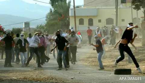 Palestinian protesters throw stones at Israeli soldiers during a demonstration against the expropriation of Palestinian land by Israel in the village of Kfar Qaddum, near the West Bank city of Nablus,in support of Palest...