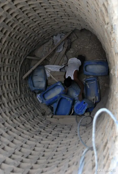Palestinians work near smuggling tunnels along the border with Egypt in Rafah, southern Gaza Strip, Sunday, Sept. 30, 2012. Hamas officials say that over the past two months, Egypt has closed about 80 percent of the roug...