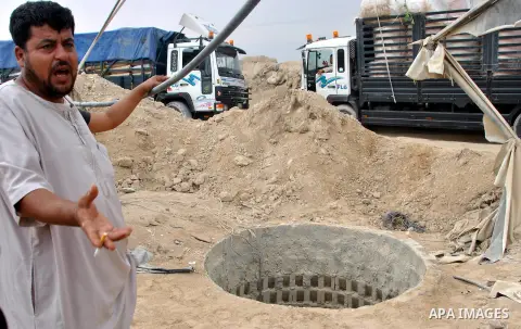 Palestinians work near smuggling tunnels along the border with Egypt in Rafah, southern Gaza Strip, Sunday, Sept. 30, 2012. Hamas officials say that over the past two months, Egypt has closed about 80 percent of the roug...