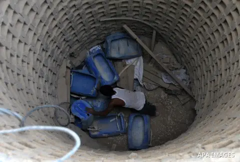 Palestinians work near smuggling tunnels along the border with Egypt in Rafah, southern Gaza Strip, Sunday, Sept. 30, 2012. Hamas officials say that over the past two months, Egypt has closed about 80 percent of the roug...