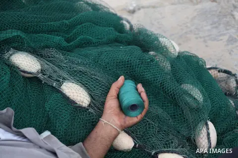 A Palestinian fisherman prepares his net at Gaza Seaport in Gaza City September 30, 2012. Israel confines fishermen within a three-mile fishing zone in the Mediterranean Sea off the coast of Gaza, Palestinian fishermen s...