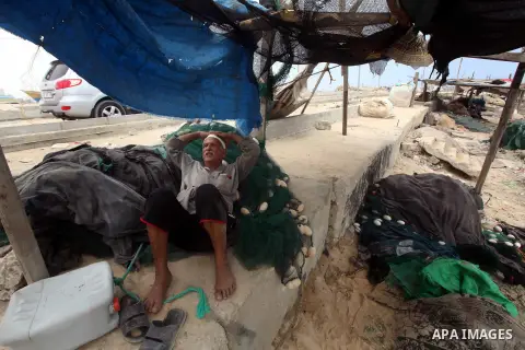 A Palestinian fisherman rests at Gaza Seaport in Gaza City September 30, 2012. Israel confines fishermen within a three-mile fishing zone in the Mediterranean Sea off the coast of Gaza, Palestinian fishermen syndicate sa...