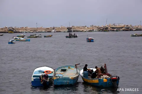 Palestinian fishermen work on their boat at Gaza Seaport in Gaza City September 30, 2012. Israel confines fishermen within a three-mile fishing zone in the Mediterranean Sea off the coast of Gaza, Palestinian fishermen s...
