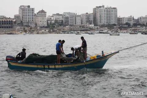 Palestinian fishermen work on their boat at Gaza Seaport in Gaza City September 30, 2012. Israel confines fishermen within a three-mile fishing zone in the Mediterranean Sea off the coast of Gaza, Palestinian fishermen s...