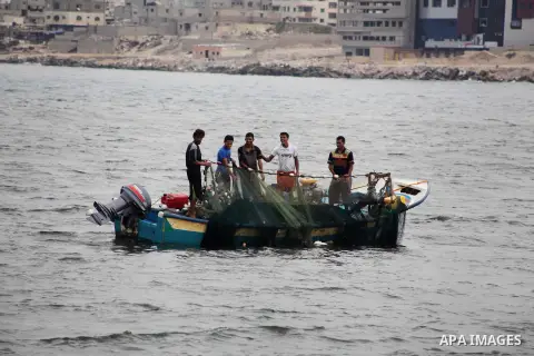 Palestinian fishermen work on their boat at Gaza Seaport in Gaza City September 30, 2012. Israel confines fishermen within a three-mile fishing zone in the Mediterranean Sea off the coast of Gaza, Palestinian fishermen s...
