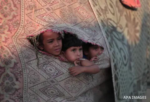 Palestinian refugee children are seen at their makeshift house in a poor suburb in the eastern Gaza City on Sept. 29, 2012. According to local and international humanitarian organization the rate of poverty in the crowde...