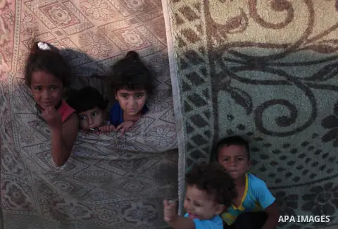 Palestinian refugee children are seen at their makeshift house in a poor suburb in the eastern Gaza City on Sept. 29, 2012. According to local and international humanitarian organization the rate of poverty in the crowde...
