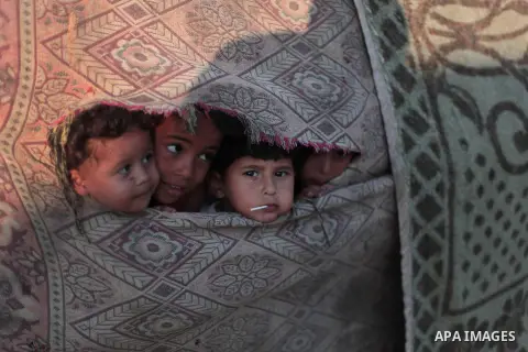 Palestinian refugee children are seen at their makeshift house in a poor suburb in the eastern Gaza City on Sept. 29, 2012. According to local and international humanitarian organization the rate of poverty in the crowde...