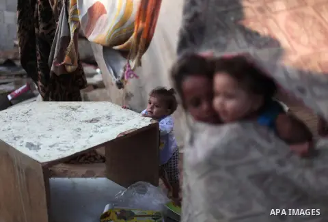 Palestinian refugee children are seen at their makeshift house in a poor suburb in the eastern Gaza City on Sept. 29, 2012. According to local and international humanitarian organization the rate of poverty in the crowde...