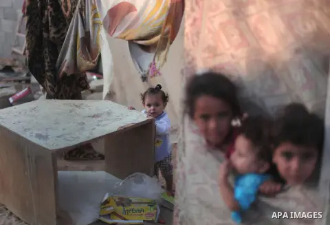 Palestinian refugee children are seen at their makeshift house in a poor suburb in the eastern Gaza City on Sept. 29, 2012. According to local and international humanitarian organization the rate of poverty in the crowde...