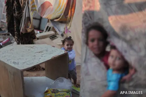 Palestinian refugee children are seen at their makeshift house in a poor suburb in the eastern Gaza City on Sept. 29, 2012. According to local and international humanitarian organization the rate of poverty in the crowde...