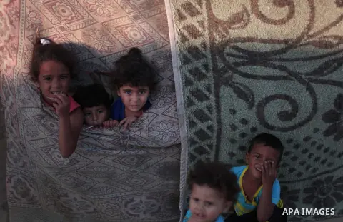 Palestinian refugee children are seen at their makeshift house in a poor suburb in the eastern Gaza City on Sept. 29, 2012. According to local and international humanitarian organization the rate of poverty in the crowde...