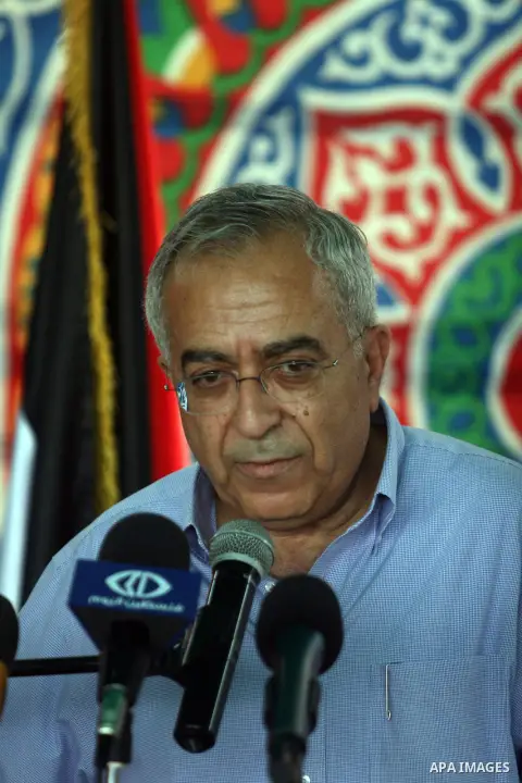Palestinian Prime Minister Salam Fayyad speaks to the press during a visit to the solar power station in the West Bank city of Jericho on September 30, 2012. Photo by Issam Rimawi
