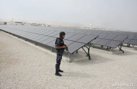 A Palestinian security officer stands guard near the solar power station in the West Bank city of Jericho on September 30, 2012. Photo by Issam Rimawi