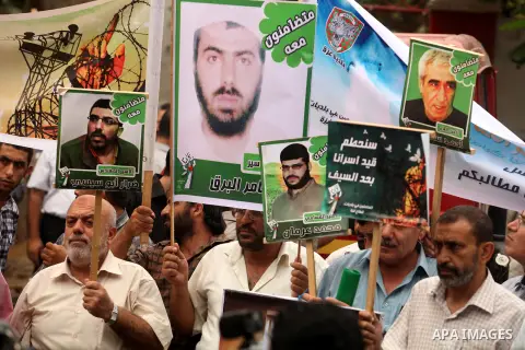 Palestinians hold pictures of their relatives prisoners held in Israeli jails during a rally calling for their release in front of the red cross office in Gaza city October 1, 2012. Photo by Majdi Fathi