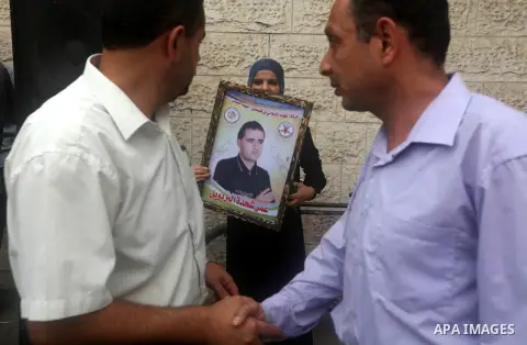 A Palestinian woman holds a picture of her relative prisoner held in Israeli jails during a rally calling for release in front of the red cross office in Gaza city October 1, 2012. Photo by Majdi Fathi