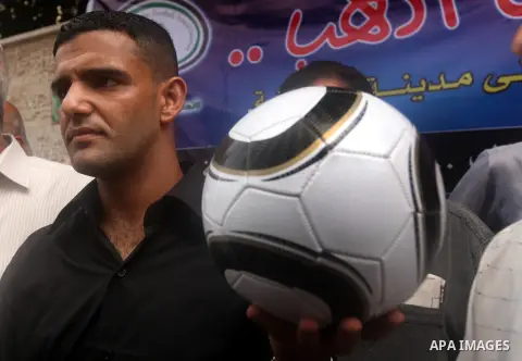 Mahmud Sarsak, Palestinian football player and former prisoner in Israel, holds a ball during a press conference outside the Red Crescent headquarters in Gaza City on October 1, 2012. Sarsak, a former prisoner who went o...