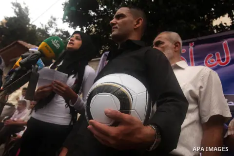 Mahmud Sarsak, Palestinian football player and former prisoner in Israel, holds a ball during a press conference outside the Red Crescent headquarters in Gaza City on October 1, 2012. Sarsak, a former prisoner who went o...