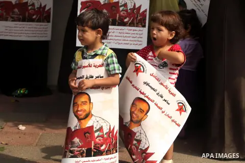 Palestinian children hold portraits of Palestinian prisoners held in Israeli jails during a rally calling for their release, in Gaza city on october 2, 2012. Photo by Majdi Fathi