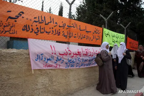 Palestinian employees protest outside the Palestinian Cabinet office against the government decision to dismiss them from their job because of their political affiliation, in the West Bank city of Ramallah on October 1,...