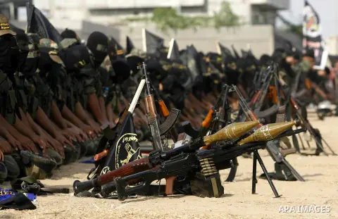 Palestinian militants from the Islamic Jihad, an armed wing of the Al-Quds Brigades Pray during a rally marking the 25th anniversary of the Jihad movement's establishment in Rafah in the southern Gaza Strip on October 2,...