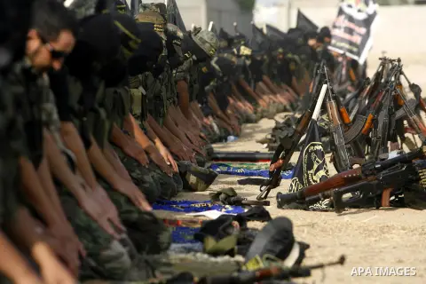 Palestinian militants from the Islamic Jihad, an armed wing of the Al-Quds Brigades Pray during a rally marking the 25th anniversary of the Jihad movement's establishment in Rafah in the southern Gaza Strip on October 2,...