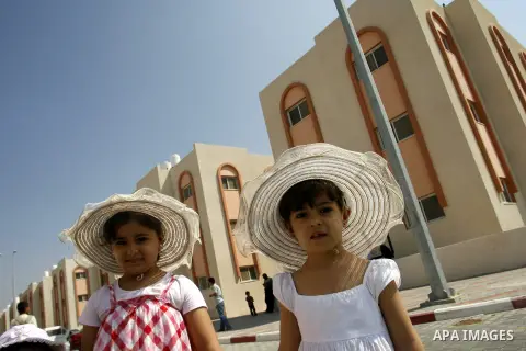 Palestinians walk in front of their new houses in a project funded by the United Nations Relief and Works Agency for Palestine Refugees (UNRWA) in Rafah, in the southern of Gaza Strip on Oct. 03, 2012. Palestinians whose...