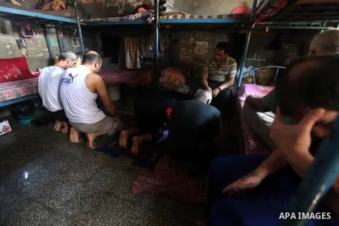 Palestinian prisoners sit in their cell in the Hamas-run Ansar prison in Gaza City on October 4, 2012. The jail holds prisoners convicted of all types of offenses. Human Rights Watch accused Gaza's ruling Hamas movement...