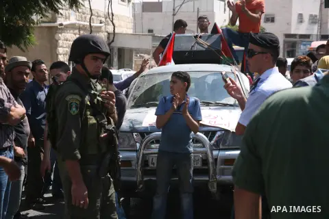 Palestinian police officers stop protesters during a demonstration against Prime Minister Salam Fayyad and the high cost of living in the West Bank city of Hebron on Oct. 4, 2012. The Palestinian Authority is undergoing...