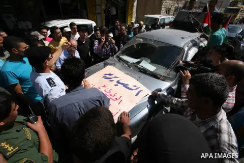 Palestinian police officers stop protesters during a demonstration against Prime Minister Salam Fayyad and the high cost of living in the West Bank city of Hebron on Oct. 4, 2012. The Palestinian Authority is undergoing...