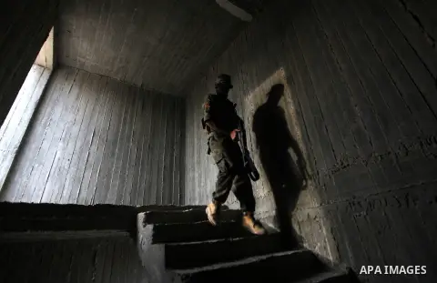 An Islamic Jihad militant guards during a ceremony marking the 25th anniversary of the movement's foundation and the 17th anniversary of the death of the group's leader Fathi Shekaki in Gaza City October 4, 2012. Photo b...