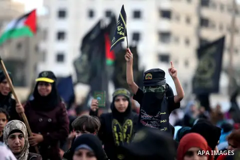 Palestinian supporters of Islamic Jihad movement take part in a ceremony marking the 25th anniversary of the movement's foundation and the 17th anniversary of the death of the group's leader Fathi Shekaki in Gaza City Oc...