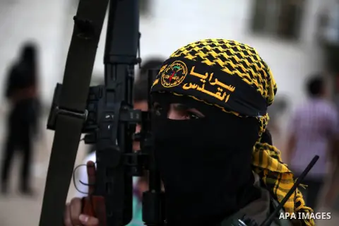An Islamic Jihad militant stands guard during a ceremony marking the 25th anniversary of the movement's foundation and the 17th anniversary of the death of the group's leader Fathi Shekaki in Gaza City October 4, 2012. P...