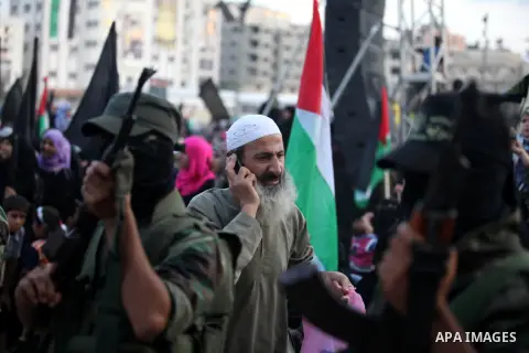 Islamic Jihad militants stand guard during a ceremony marking the 25th anniversary of the movement's foundation and the 17th anniversary of the death of the group's leader Fathi Shekaki in Gaza City October 4, 2012. Phot...