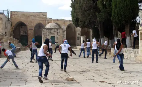 Palestinian worshippers throw stones toward Israeli forces, not pictured, during clashes at the Al Aqsa Mosque compound, known by the Jews as the Temple Mount, in Jerusalem's Old City, Friday, Oct. 5, 2012. Earlier this...
