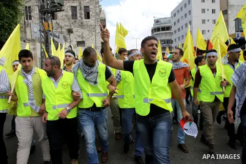 Palestinian supporters of the Fatah party wave the party's flags during a campaign rally for its candidates running in the local council elections in the West Bank city of Nablus on October 6, 2012.. Photo by Nedal Eshta...