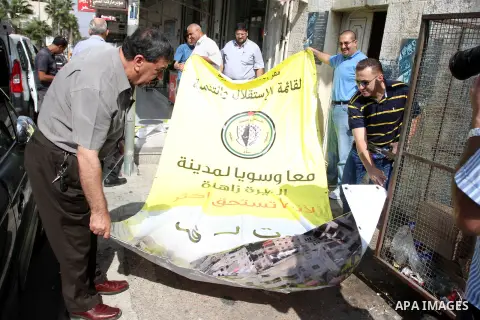 Palestinian supporters of the Fatah party wave the party's flags during a campaign rally for its candidates running in the local council elections in the West Bank city of Ramallah on the first day of campaigning for the...