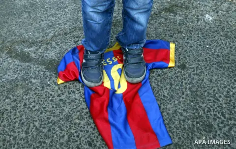 A Palestinian child stands on Spanish FC Barcelona's shirt , during a demonstration outside the Spanish consulate in eastern Jerusalem on October 7, 2012 to protest against Barcelona's invitation of Shalit to attend toda...