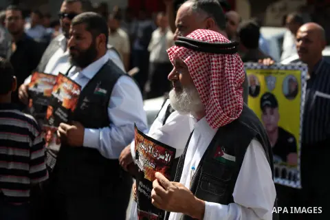 Palestinian men hold pictures of their relatives prisoners held in Israeli jails during a protest calling for their release in front of the red cross office in Gaza city October 08, 2012 . Photo by Majdi Fathi