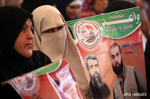 Palestinian women hold pictures of their relatives prisoners held in Israeli jails during a protest calling for their release in front of the red cross office in Gaza city October 08, 2012 . Photo by Majdi Fathi