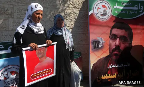 Palestinian women hold pictures of their relatives prisoners held in Israeli jails during a protest calling for their release in front of the red cross office in Gaza city October 08, 2012 . Photo by Majdi Fathi